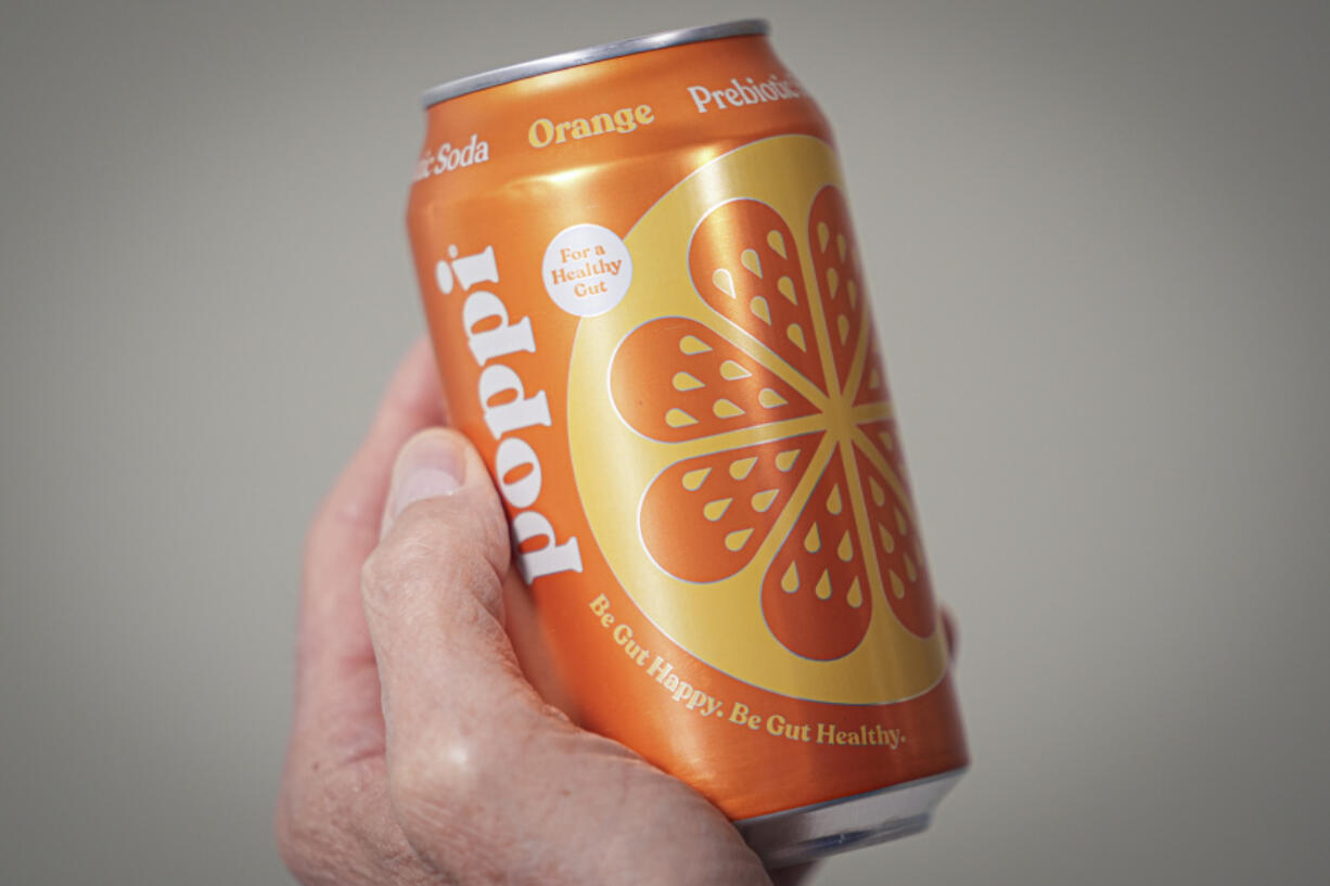 FILE - A can of Poppi prebiotic soda is shown on April 10, 2024, in New York. Soda brand Poppi is being sued by a consumer who says the brand isn&rsquo;t improving gut health as much as it claims.