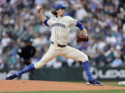 Seattle Mariners starting pitcher Logan Gilbert throws to a Texas Rangers batter during the first inning in a baseball game, Sunday, June 16, 2024, in Seattle.