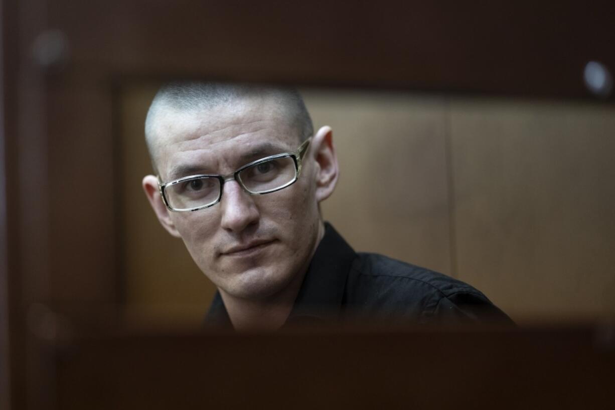FILE - U.S. citizen Robert Woodland Romanov sits in a defendant&rsquo;s cage before a court session on drug-related charges in Moscow, Russia, on May 30, 2024. Russian media reported his name matches that of a U.S. citizen interviewed by the Komsomolskaya Pravda newspaper in 2020 in which he said he was born in the Perm region in the Ural Mountains in 1991 and adopted by an American couple when he was 2.