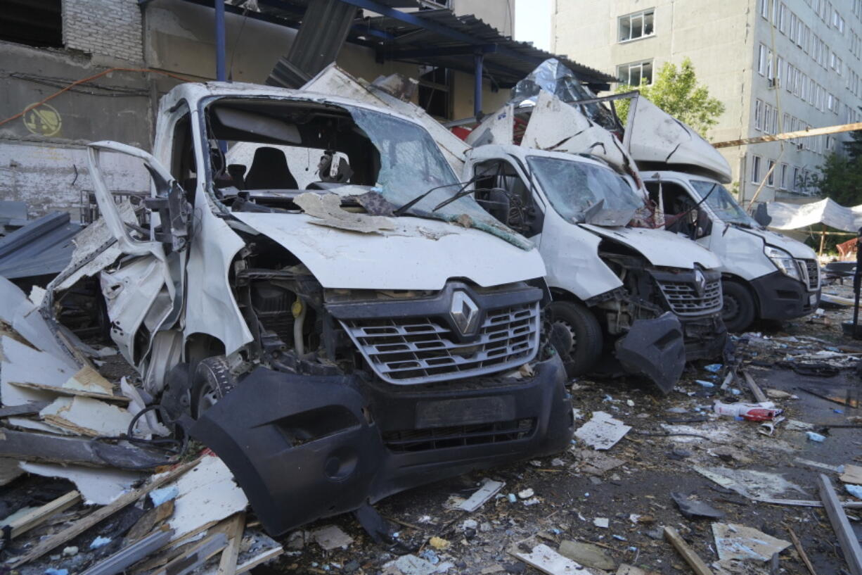A view of Nova Poshta delivery vehicles damaged after a Russian attack in Kharkiv, Ukraine, Sunday, June 30, 2024. One person was killed and several were injured.