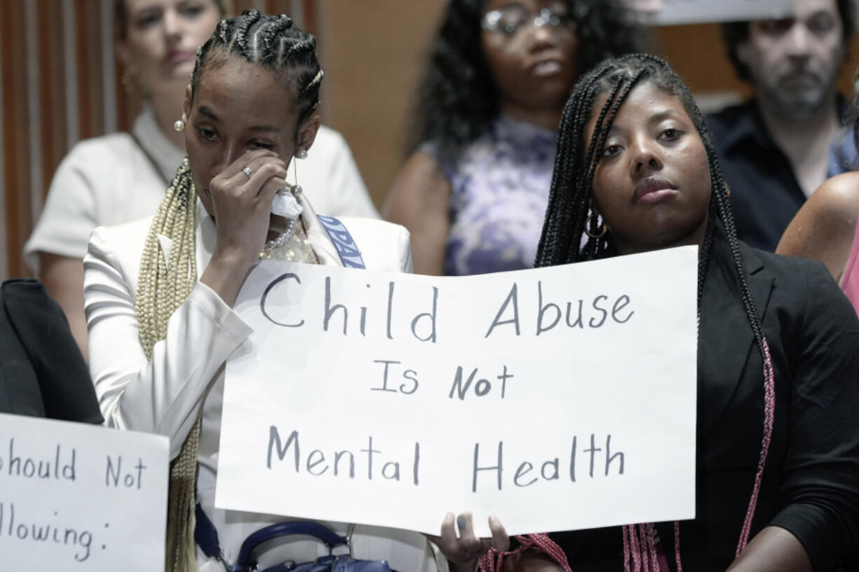 Victims are emotional during a news conference with survivors of abused and neglected youth at residential treatment facilities (RTFs) and advocates, on the need for Congress to act to protect children and reform RTFs, Wednesday, June 12, 2024, on Capitol Hill in Washington.