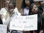 Victims are emotional during a news conference with survivors of abused and neglected youth at residential treatment facilities (RTFs) and advocates, on the need for Congress to act to protect children and reform RTFs, Wednesday, June 12, 2024, on Capitol Hill in Washington.