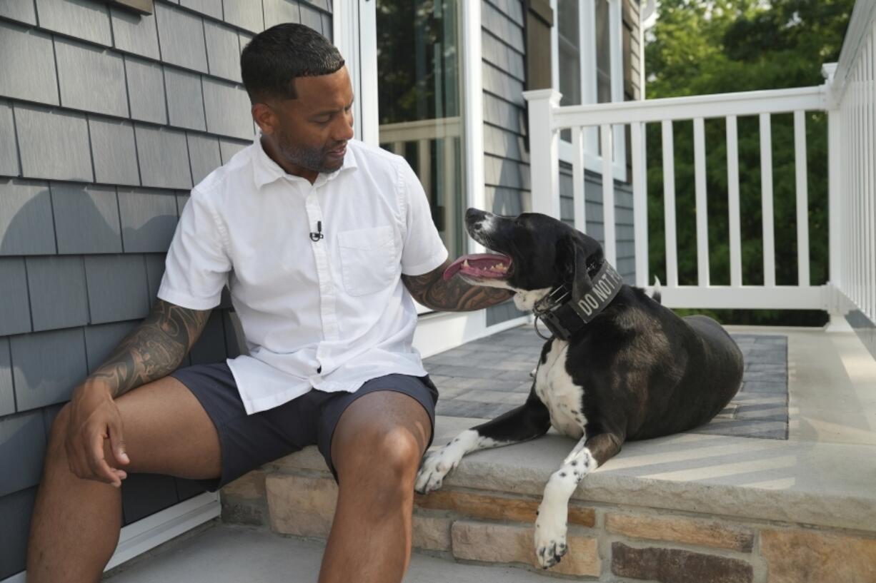 Dave Crenshaw sits June 3 with his service dog, Doc, in front of his home in Kearny, N.J. Crenshaw served with the Army National Guard in Iraq and was diagnosed with PTSD in 2016 while working undercover in law enforcement.
