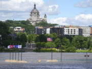 Rising water from the Mississippi River envelopes the riverbank, Wednesday, June 26, 2024, at Harriet Island Regional Park in St. Paul, Minn.