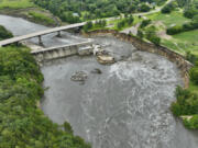 Floodwater continues to carve a channel around the Rapidan Dam, Thursday, June 27, 2024, near Mankato, Minn. Water breached the earthen abutment early Monday morning and rapidly eroded the west bank of the Blue Earth River.