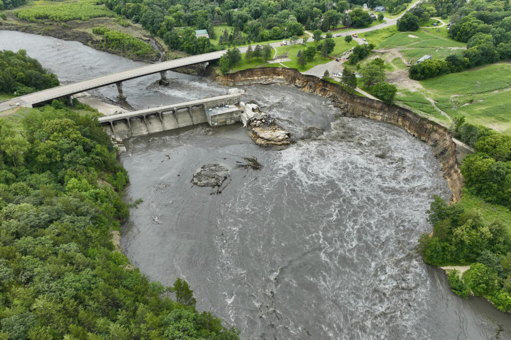 Floodwater continues to carve a channel around the Rapidan Dam, Thursday, June 27, 2024, near Mankato, Minn. Water breached the earthen abutment early Monday morning and rapidly eroded the west bank of the Blue Earth River.