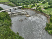 Floodwater continues to carve a channel around the Rapidan Dam, Thursday, June 27, 2024, near Mankato, Minn. Water breached the earthen abutment early Monday morning and rapidly eroded the west bank of the Blue Earth River.