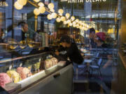 FILE - People working at a gelato shop serve customers in New York on February 18, 2024. Small businesses are increasingly concerned about payment fraud according to a survey from regional bank KeyBank.