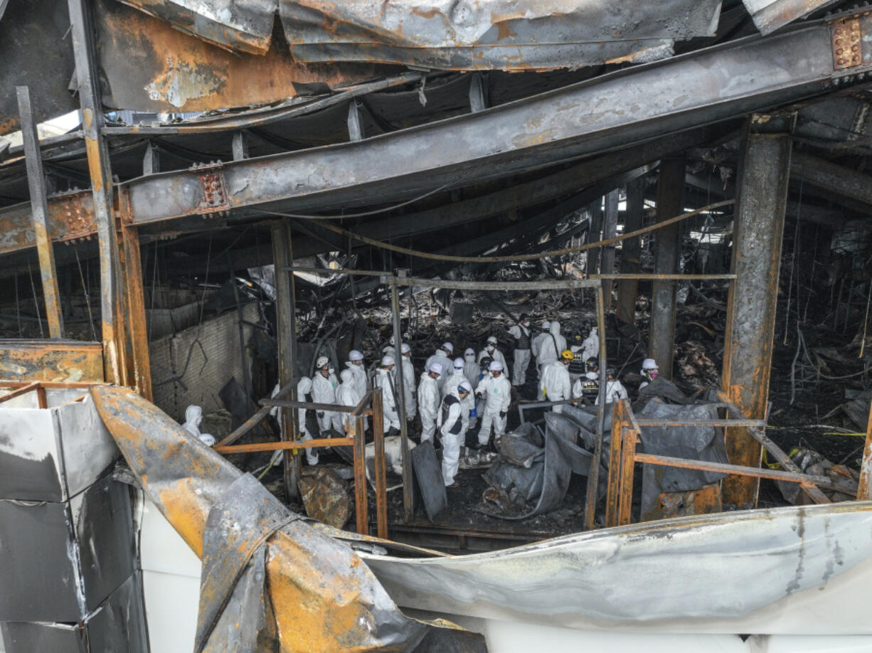 A joint investigation team investigate the scene at the site of a burnt battery manufacturing factory in Hwaseong, South Korea, Tuesday, June 25, 2024. Forensic and other experts combed through the charred ruins of a factory building near South Korea&rsquo;s capital to find the cause of a devastating fire that killed multiple people, mostly Chinese migrant workers, in one of the country&rsquo;s deadliest blazes in years.