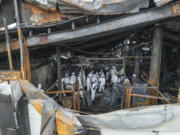 A joint investigation team investigate the scene at the site of a burnt battery manufacturing factory in Hwaseong, South Korea, Tuesday, June 25, 2024. Forensic and other experts combed through the charred ruins of a factory building near South Korea&rsquo;s capital to find the cause of a devastating fire that killed multiple people, mostly Chinese migrant workers, in one of the country&rsquo;s deadliest blazes in years.