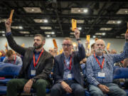 Messengers raise their ballots in support of a motion put up for vote during a Southern Baptist Convention annual meeting Tuesday, June 11, 2024, in Indianapolis.