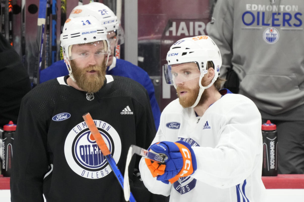 Edmonton Oilers center Connor McDavid, right, and defenseman Mattias Ekholm talk during hockey practice before Media Day for the Stanley Cup Finals, Friday, June 7, 2024, in Sunrise, Fla. The Oilers take on the Florida Panthers in Game 1 on Saturday in Sunrise.