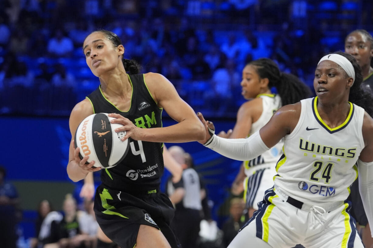 Seattle Storm guard Skylar Diggins-Smith (4) pulls the ball away from Dallas Wings guard Arike Ogunbowale (24) during the second half of a WNBA basketball basketball game in Arlington, Texas, Thursday, June 13, 2024.