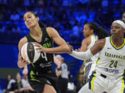 Seattle Storm guard Skylar Diggins-Smith (4) pulls the ball away from Dallas Wings guard Arike Ogunbowale (24) during the second half of a WNBA basketball basketball game in Arlington, Texas, Thursday, June 13, 2024.