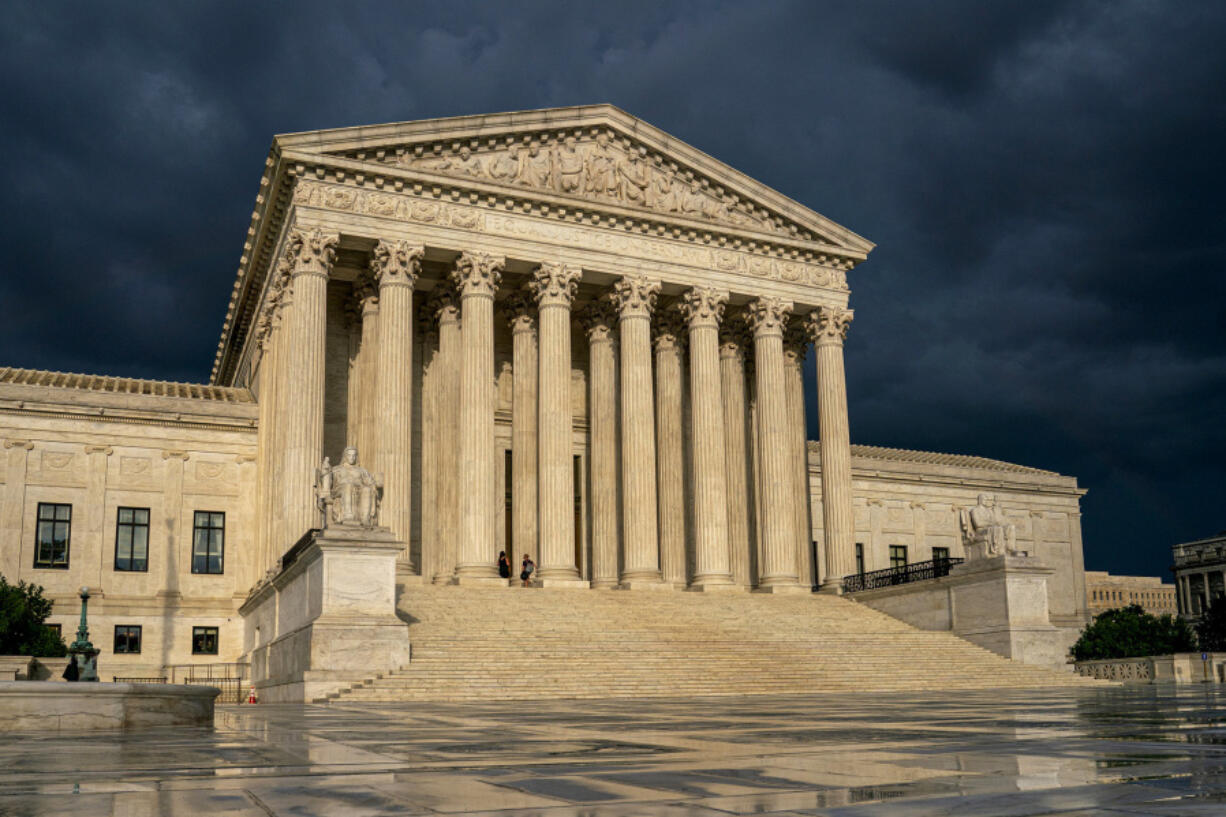 FILE - The Supreme Court is seen under stormy skies in Washington, June 20, 2019. In the coming days, the Supreme Court will confront a perfect storm mostly of its own making, a trio of decisions stemming directly from the Jan. 6, 2021 attack on the U.S. Capitol.  (AP Photo/J.