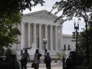 People walk past the Supreme Court on Thursday, June 27, 2024, in Washington.