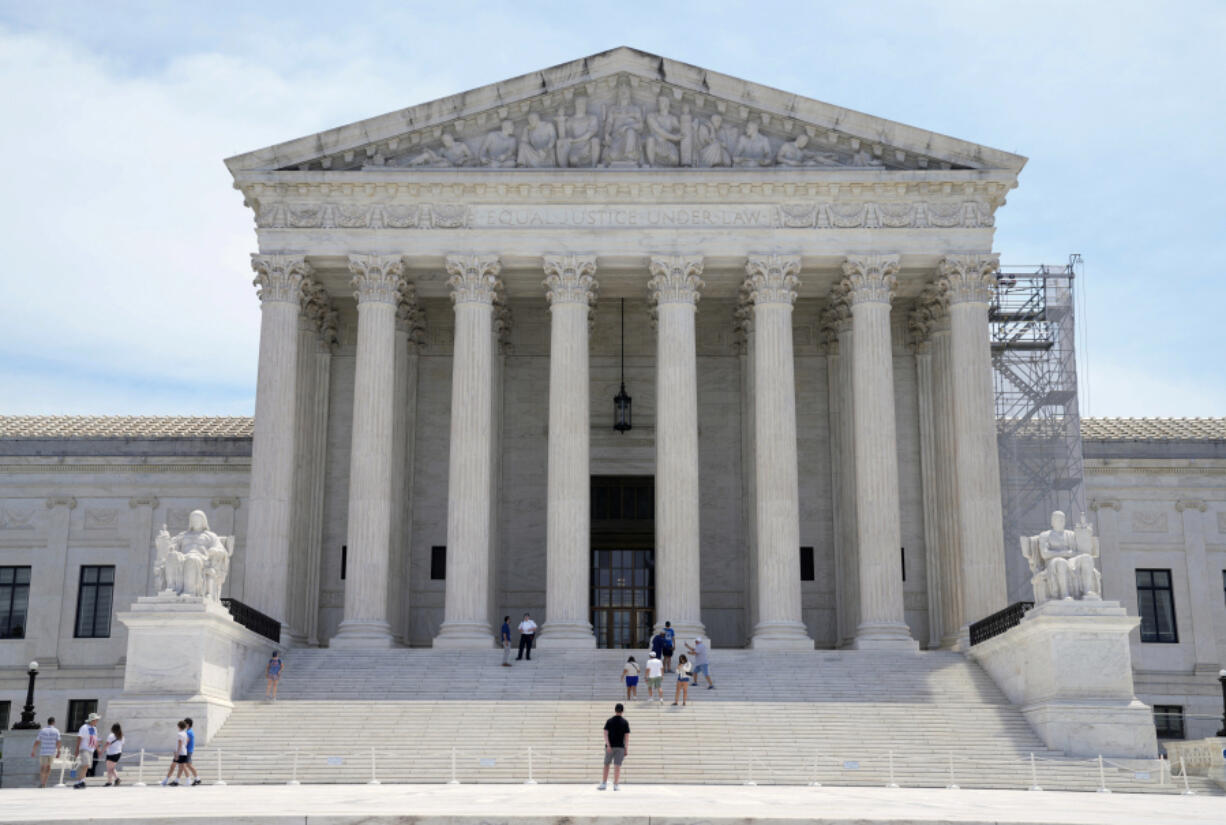 FILE - Tourists visit the Supreme Court, Tuesday, June 25, 2024, in Washington. The Supreme Court has overturned the bribery conviction of a former Indiana mayor in an opinion that narrows the scope of public corruption law. The high court on Wednesday sided with James Snyder, who was convicted of taking $13,000 from a trucking company after prosecutors said he steered about $1 million worth of city contracts their way. Snyder has maintained his innocence, saying the money was payment for consulting work. Snyder is a Republican.