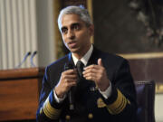 FILE - Surgeon General Dr. Vivek Murthy speaks during an event on the White House complex in Washington, April 23, 2024. Murthy is asking Congress to require warning labels on social media platforms that are similar to those that appear on cigarette boxes.