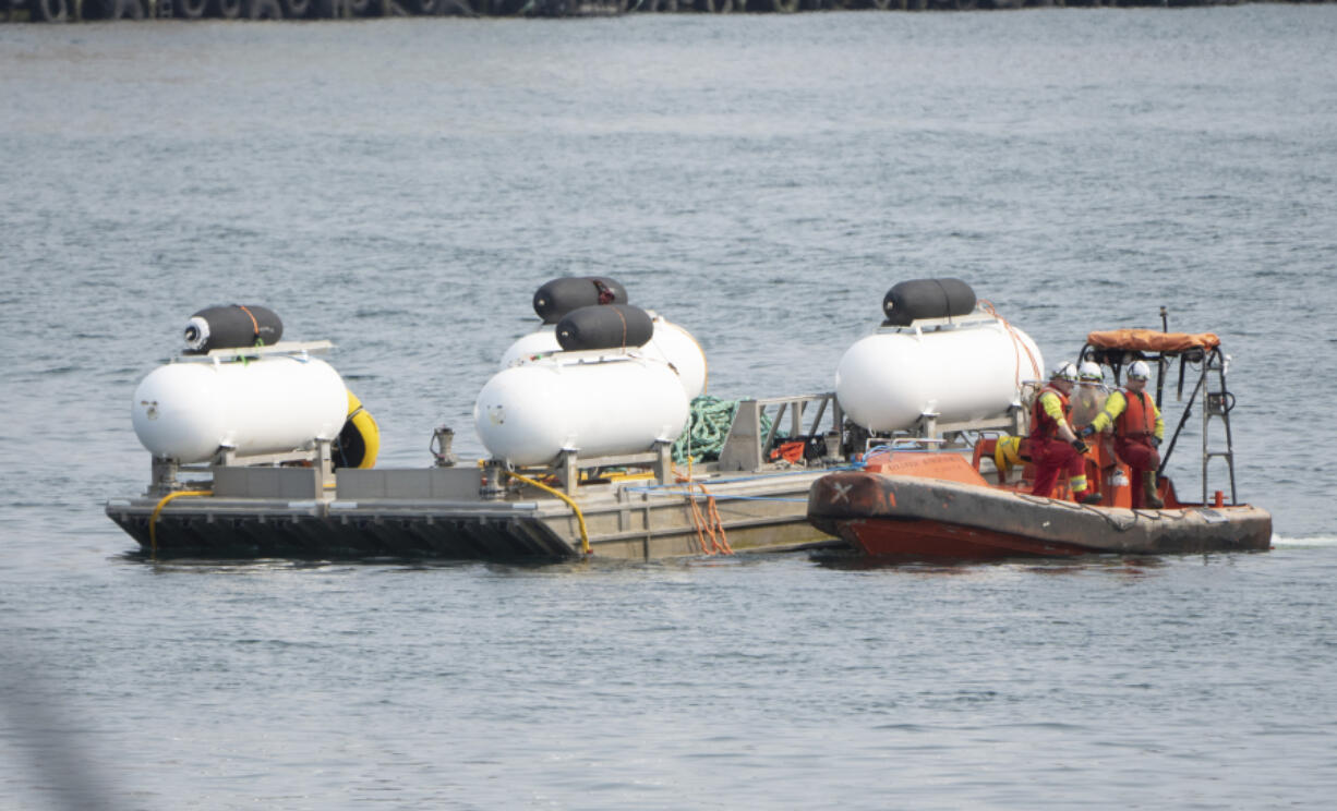 FILE-The Titan launch barge is moved to the Coast Guard yard at port in St. John&rsquo;s, Newfoundland in this June 24, 2023, file photo.  The deadly implosion of an experimental submersible en route to the deep-sea grave of the Titanic last June has not dulled the desire for deep-sea exploration. Tuesday, June 18, 2024, marks one year since the Titan vanished on its way to the historic wreckage site.