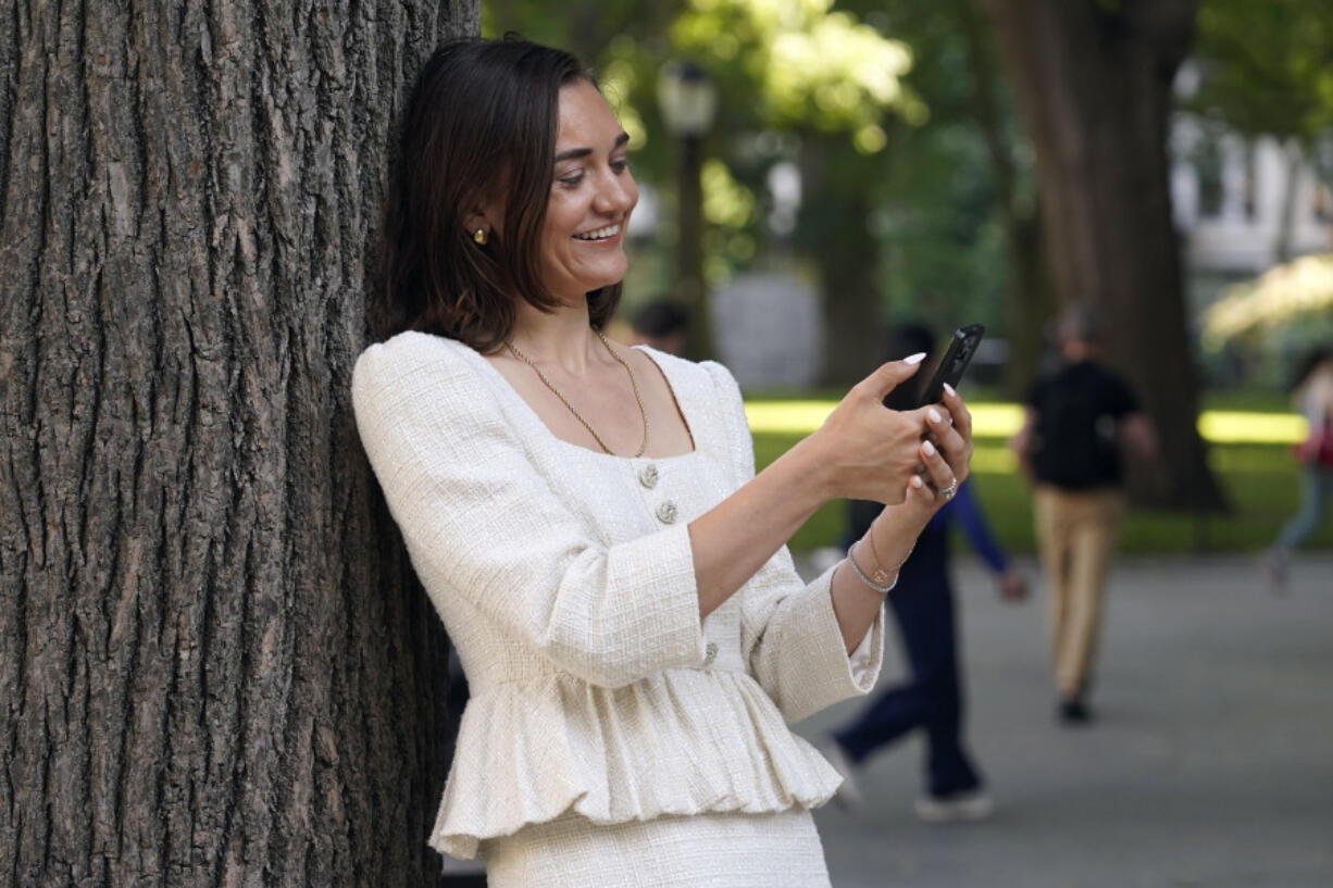 Larissa May, of HalfTheStory, checks her phone Tuesday in New York&rsquo;s Madison Square Park. The site works with young people to build better relationships with technology.