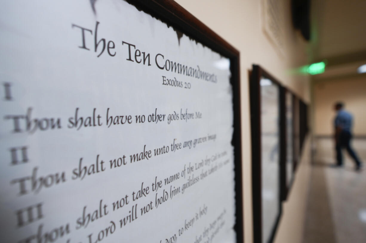 FILE - A copy of the Ten Commandments is posted along with other historical documents in a hallway of the Georgia Capitol, Thursday, June 20, 2024, in Atlanta. Civil liberties groups filed a lawsuit Monday, June 24, challenging Louisiana&rsquo;s new law that requires the Ten Commandments to be displayed in every public school classroom.