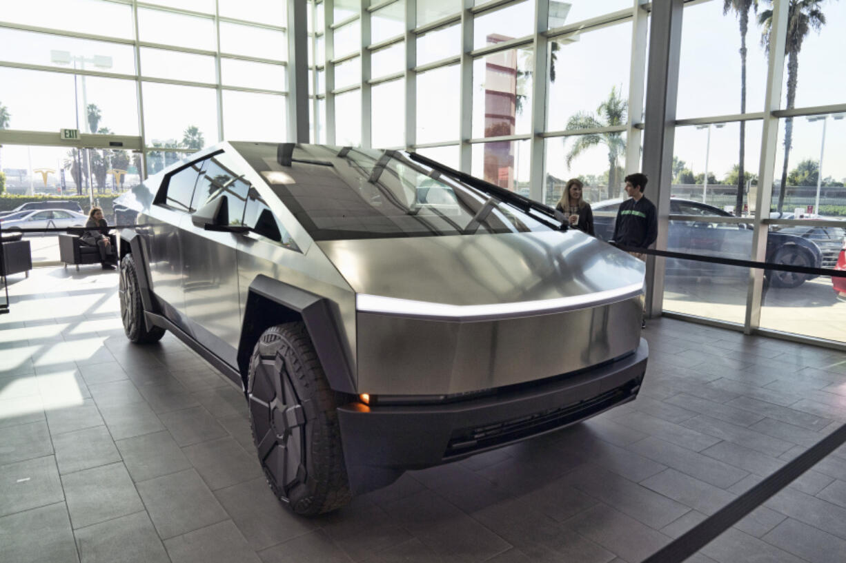 FILE - A Tesla Cybertruck is on display at the Tesla showroom in Buena Park, Calif., Dec. 3, 2023. Tesla is recalling its futuristic new Cybertruck pickup for the fourth time in the U.S. to fix problems with trim pieces that can come loose and front windshield wipers that can fail. The new recalls, announced in documents posted Tuesday, June 25, 2024, by the National Highway Traffic Safety Administration, each affect more than 11,000 trucks.