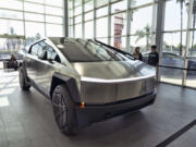 FILE - A Tesla Cybertruck is on display at the Tesla showroom in Buena Park, Calif., Dec. 3, 2023. Tesla is recalling its futuristic new Cybertruck pickup for the fourth time in the U.S. to fix problems with trim pieces that can come loose and front windshield wipers that can fail. The new recalls, announced in documents posted Tuesday, June 25, 2024, by the National Highway Traffic Safety Administration, each affect more than 11,000 trucks.