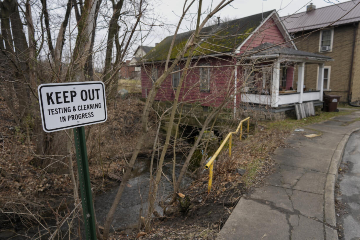 FILE - A sign reads &quot;Keep Out Testing &amp; Cleaning in Progress&quot; near the Sulphur Run Creek as it flows under homes in East Palestine, Ohio, on Jan. 30, 2024. The Internal Revenue Service decided Wednesday, June 5, 2024, that most people who received money from Norfolk Southern in the wake of the train derailment won&#039;t have to pay taxes on millions of dollars in aid payments.