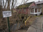 FILE - A sign reads &quot;Keep Out Testing &amp; Cleaning in Progress&quot; near the Sulphur Run Creek as it flows under homes in East Palestine, Ohio, on Jan. 30, 2024. The Internal Revenue Service decided Wednesday, June 5, 2024, that most people who received money from Norfolk Southern in the wake of the train derailment won&#039;t have to pay taxes on millions of dollars in aid payments.