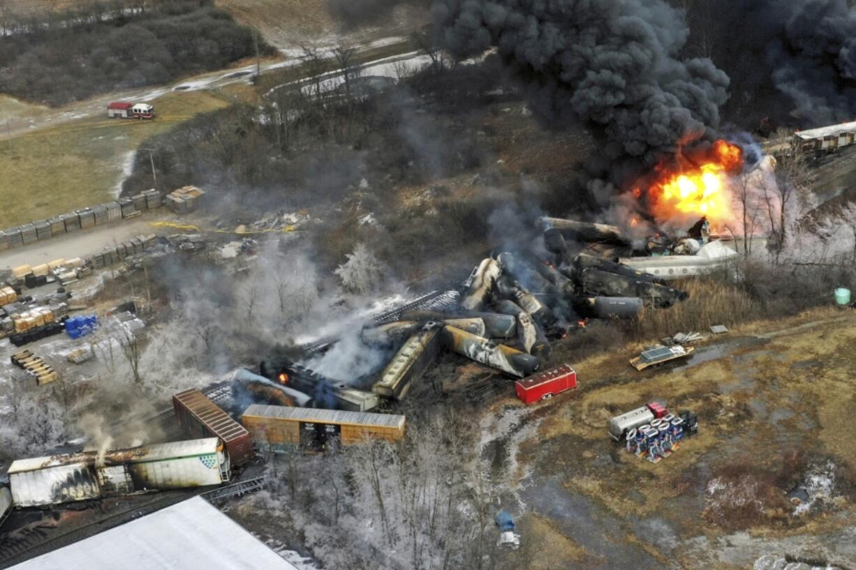 FILE - Debris from a Norfolk Southern freight train lies scattered and burning along the tracks on Feb. 4, 2023, the day after it derailed in East Palestine, Ohio. East Palestine residents will learn more Tuesday about the fiery Norfolk Southern train crash that derailed their lives last year when the National Transportation Safety Board holds another hearing in their eastern Ohio hometown to discuss what their investigation uncovered and their recommendations to prevent future disasters. (AP Photo/Gene J.