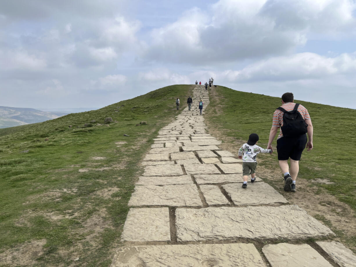 Hikers make their way up Mam Tor, a 517 meters high (1,696 feet) hill in England&rsquo;s Peak District National Park on May 8, 2024.