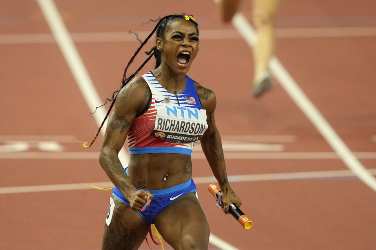 FILE - Sha&#039;Carri Richardson, of the United States, celebrates after she crosses the finish line to anchor her team to gold in the Women&#039;s 4x100-meters relay final during the World Athletics Championships in Budapest, Hungary, Aug. 26, 2023. There is one more item to scratch off the list before everyone from Richardson to Noah Lyles to Sydney McLaughlin-Levrone embark on their trips to Paris for the Olympics: Making the Olympic team. US track trials start Friday, June21, 2024.