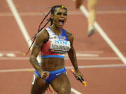FILE - Sha&#039;Carri Richardson, of the United States, celebrates after she crosses the finish line to anchor her team to gold in the Women&#039;s 4x100-meters relay final during the World Athletics Championships in Budapest, Hungary, Aug. 26, 2023. There is one more item to scratch off the list before everyone from Richardson to Noah Lyles to Sydney McLaughlin-Levrone embark on their trips to Paris for the Olympics: Making the Olympic team. US track trials start Friday, June21, 2024.