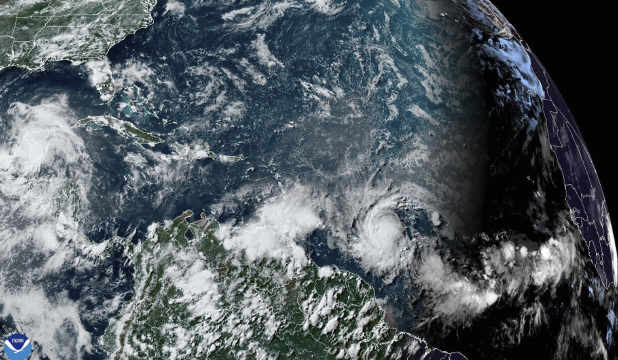 This National Oceanic and Atmospheric Administration satellite image taken at 4:20pm EDT shows hurricane Beryl, lower center right, as it strengthens over the Atlantic Ocean and churns toward the southeast Caribbean on Saturday, June 29, 2024.
