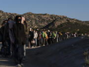 Chinese migrants wait to be processed after crossing the border with Mexico on May 8, 2024, near Jacumba Hot Springs, Calif. The U.N.&rsquo;s refugee agency has expressed concern over plans for new asylum restrictions in the United States. President Joe Biden on Tuesday unveiled plans to enact immediate significant restrictions on migrants seeking asylum at the U.S.-Mexico border as the White House tries to neutralize immigration as a political liability ahead of the November elections.