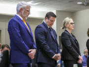 Jeffrey Nelson, flanked by attorneys, stands at the King County Maleng Regional Justice Center in Kent, Wash., on Thursday, June 27, 2024. A jury found the suburban Seattle police officer guilty of murder in the 2019 shooting death of a homeless man outside a convenience store, marking the first conviction under a Washington state law easing prosecution of law enforcement officers for on-duty killings.