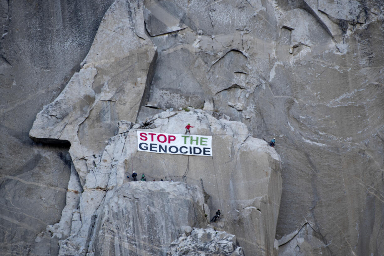 Climbers With Palestine, a rock climbing activist collective, hang a banner reading &quot;Stop the genocide&quot; from El Capitan in Yosemite Valley, Calif., Monday, June 17, 2024.