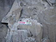 Climbers With Palestine, a rock climbing activist collective, hang a banner reading &quot;Stop the genocide&quot; from El Capitan in Yosemite Valley, Calif., Monday, June 17, 2024.