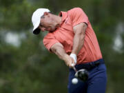 Rory McIlroy, of Northern Ireland, hits his tee shot on the 11th hole during the first round of the U.S. Open.