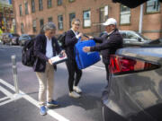 Dr. Amy Attas, left, and licensed veterinary technician Jeanine Lunz, center arrive at a clients apartment building April 23 in New York.