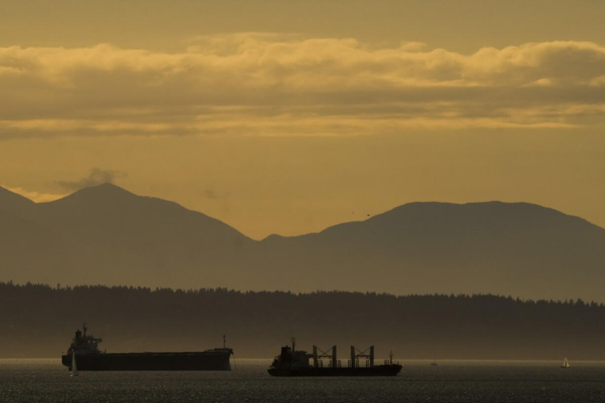 Ships on Elliott Bay are silhouetted against the evening sun, Wednesday, June 12, 2024, in Seattle.