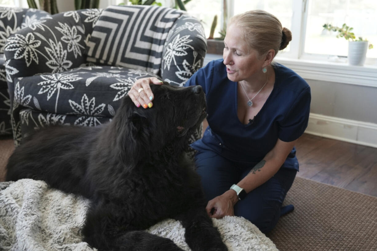 Dr. Lisa Walling greets her 13-year-old hospice patient, Rugby, a Newfoundland, in the dog&rsquo;s home in Bedford, N.Y., on May 7.