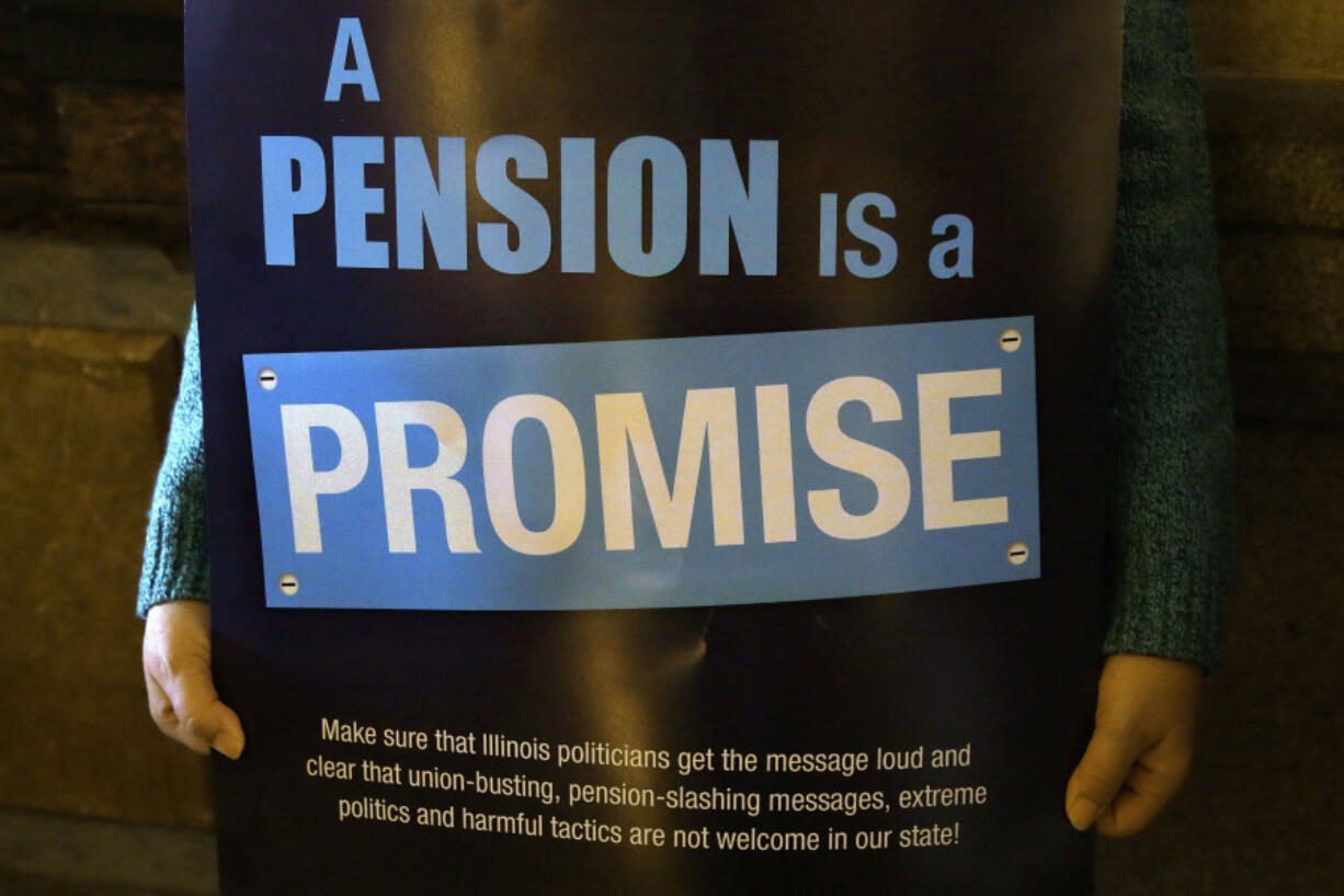 FILE - In this Jan. 3, 2013 photo, a &ldquo;Pension Promise&rdquo; sign is seen at the Illinois State Capitol in Springfield Ill.,  Jan. 3, 2013.  Democrats are putting a spotlight on more than than 1 million union workers and retirees whose pensions are being saved under a law enacted in the summer of 2021. The Butch Lewis Act will ultimately stop cuts to the retirement benefits of 2 million workers and retirees across the country. The law was part of the American Rescue Plan passed by Congress along party lines to ultimately stall the insolvency of roughly 200 multi-employer pension plans for 30 years.