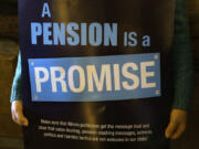 FILE - In this Jan. 3, 2013 photo, a &ldquo;Pension Promise&rdquo; sign is seen at the Illinois State Capitol in Springfield Ill.,  Jan. 3, 2013.  Democrats are putting a spotlight on more than than 1 million union workers and retirees whose pensions are being saved under a law enacted in the summer of 2021. The Butch Lewis Act will ultimately stop cuts to the retirement benefits of 2 million workers and retirees across the country. The law was part of the American Rescue Plan passed by Congress along party lines to ultimately stall the insolvency of roughly 200 multi-employer pension plans for 30 years.