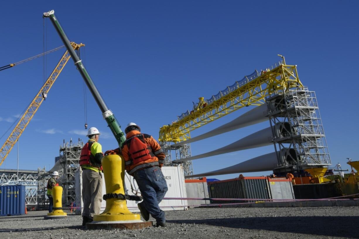 FILE - A generator and its blades are prepared for transport to the open ocean for the South Fork Wind farm in New London, Conn., Dec. 4, 2023. The World Bank upgraded the outlook for the global economy in 2024, citing continued resilience and strength in the United States.