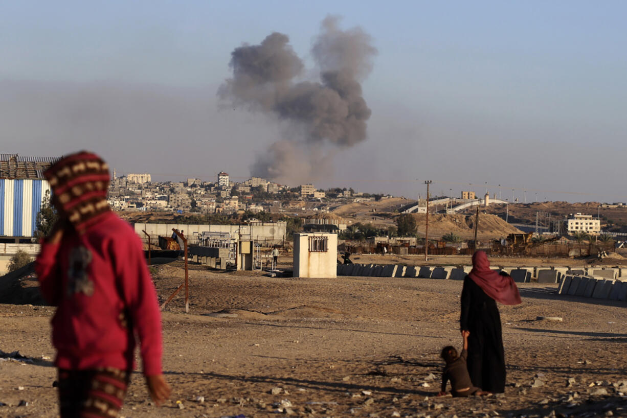 FILE - Smoke rises following an Israeli airstrike on buildings near the separating wall between Egypt and Rafah, southern Gaza Strip, Tuesday, May 7, 2024. An order by the top United Nations court for Israel to halt its military offensive in the southern Gaza city of Rafah deepens its disconnect with the United States.