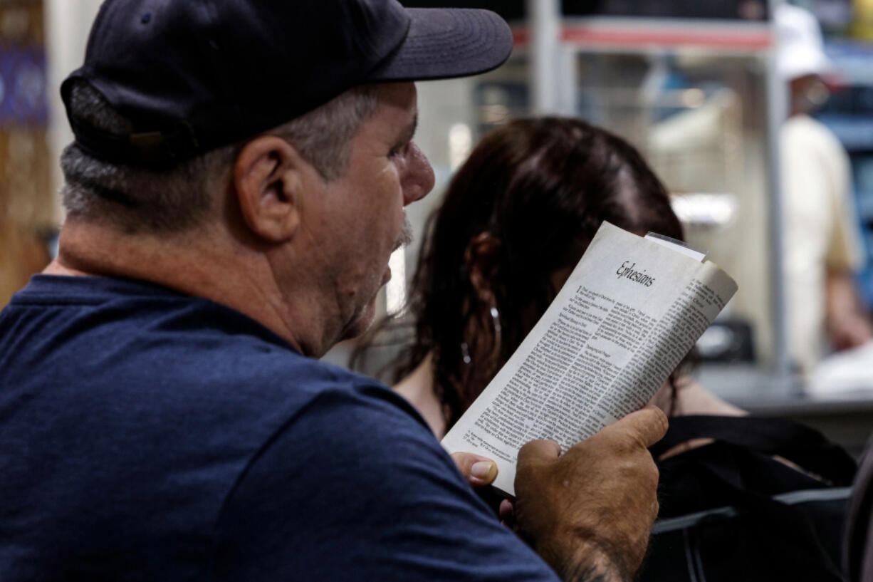 Mike Eurich reads from the Bible with other worshippers during a weekly gathering at a Columbia New Jersey truck stop TA Travel Center by the Delaware River. Wednesday, June 5, 2024. (Steven M. Falk/The Philadelphia Inquirer/TNS) (Steven M.