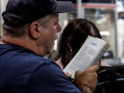 Mike Eurich reads from the Bible with other worshippers during a weekly gathering at a Columbia New Jersey truck stop TA Travel Center by the Delaware River. Wednesday, June 5, 2024. (Steven M. Falk/The Philadelphia Inquirer/TNS) (Steven M.