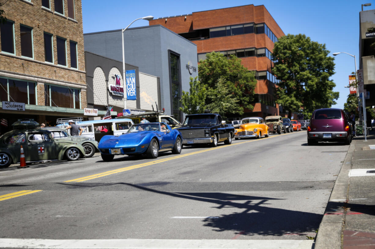 Classic cars cruise down Main Street in Vancouver during the Cruise the Couve event in 2019.