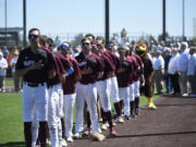 Ridgefield Raptors players line up for the national anthem before a West Coast League baseball game against the Corvallis Knights on Thursday, July 4, 2024 at Ridgefield Outdoor Recreation Complex.